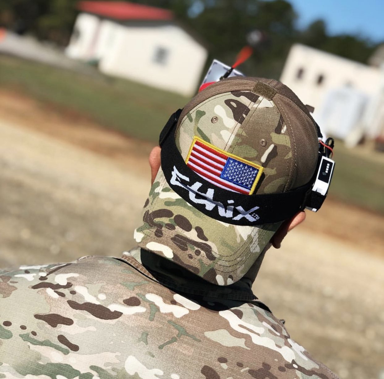 An FPV pilot in goggles watching a training site