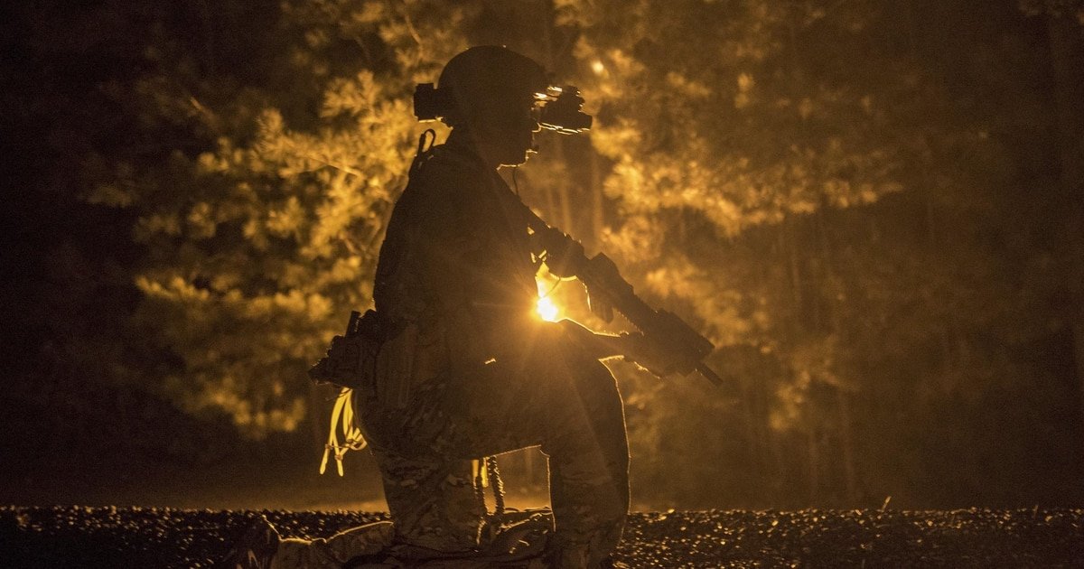 Silhouette of an operator lit by a warm glow at night